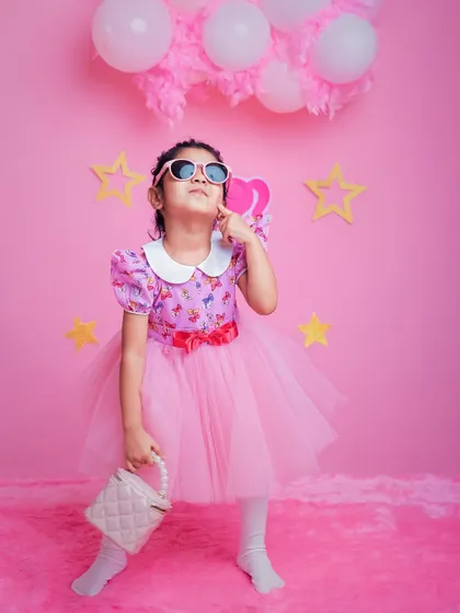 A different look from our Barbie World session, showing how an outfit and prop change can create a whole new vibe. We encourage bringing multiple outfits to add variety to your child's birthday shoot.