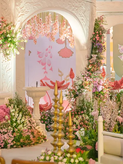A detail shot of a floral wedding stage, showing how I layer different flowers and custom backdrops to create depth and texture. The hanging pink wisteria adds a touch of whimsical romance.