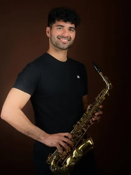 An artist's portrait with a saxophone. Incorporating a special skill or talent into a portfolio shoot makes an actor or model more memorable.