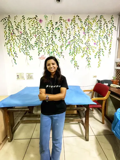 Here I am with a completed mural of hanging vines and a small pink bird. This delicate design is perfect for adding a touch of nature to a smaller space or a cozy corner.
