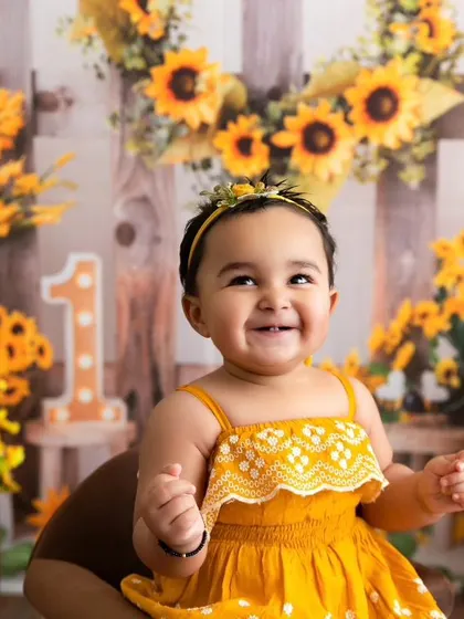 A big, beautiful smile from the birthday girl during her vibrant sunflower-themed photoshoot.