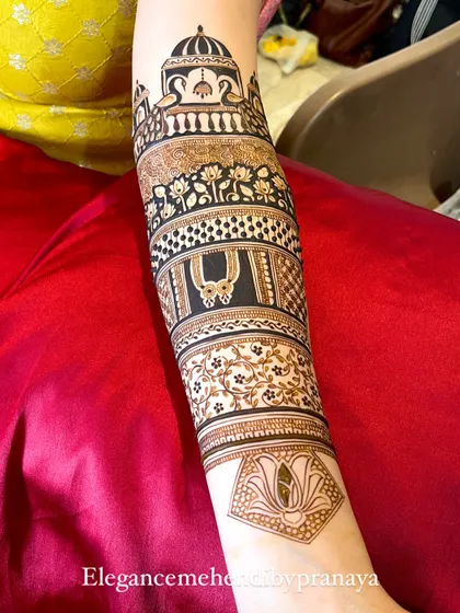 A clean and elegant startup design on the forearm, featuring peacocks, lotuses, and a 'mangalsutra' symbol.