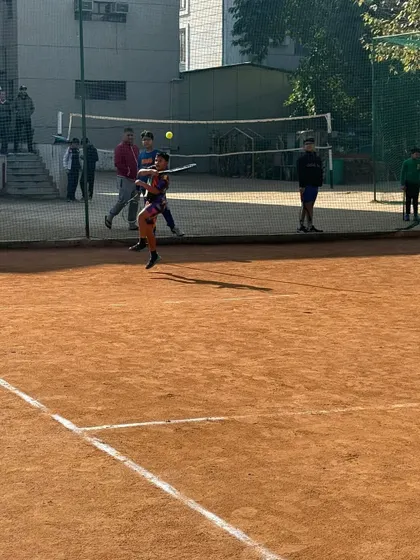 A player airborne while hitting a forehand, showing the dynamic and athletic nature of modern tennis that we train for.
