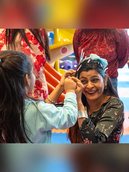 A mother and daughter share a playful moment during a Hot Wheels themed party. My goal is to create a space where families can connect and make memories.