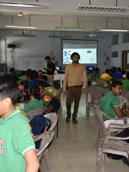 A wide shot of a busy computer lab in a Guwahati school, where we are empowering students with our Robotics and AI curriculum.
