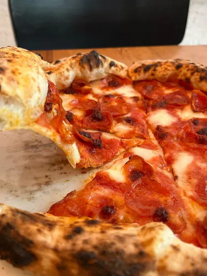 Taking a slice of the Nduja & Soppressata. Look at that perfect crust.