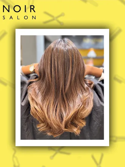 A beautiful example of a warm-toned balayage. The color melts from a natural root into lighter, caramel ends, creating a seamless and sun-kissed look.