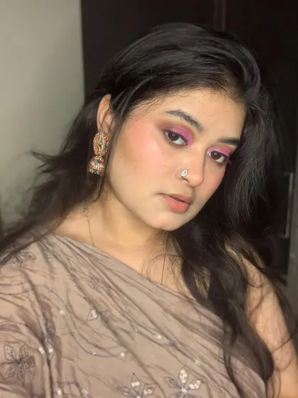 A beautiful look with shimmery pink eyeshadow and traditional jewelry.