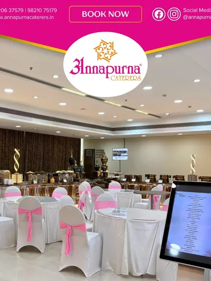 This is a clean and elegant setup at Symphony Banquet, featuring white tables with pink chair sashes. The digital menu kiosk is visible, providing guests with easy access to the day's culinary offerings.