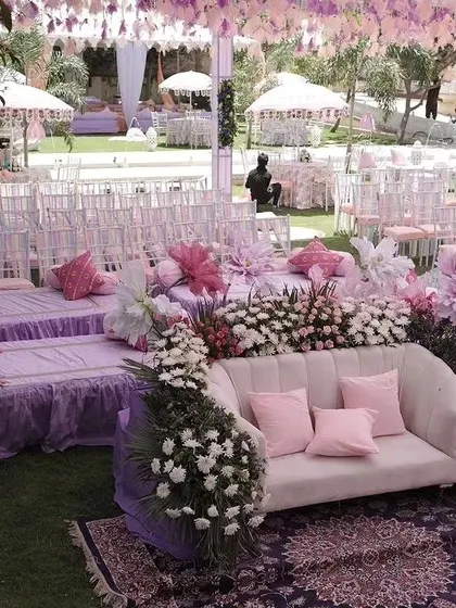 A lovely pastel-themed seating area, combining a comfortable sofa for the main guests with low floor seating and chairs for others.