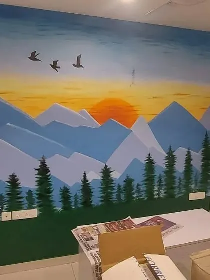 A peaceful mountain landscape mural painted at sunset, bringing a sense of natural tranquility and open space into the room.