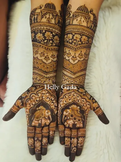The full view of the intricate bridal design, with majestic elephants on the palms and a symphony of traditional motifs on the arms.