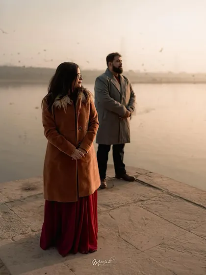 A serene portrait by the water's edge, capturing a moment of quiet reflection and togetherness.