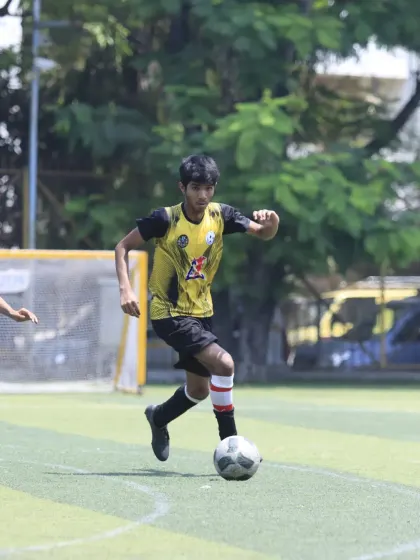 A player dribbling at speed, looking for an opening in the opposition's defense. This shows the confidence and attacking flair of our U-15 squad.
