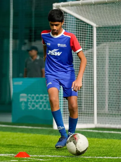 A player practices his ball control near the goal. Our sessions include position-specific drills to hone skills for every area of the pitch.