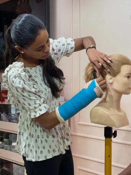The focus and determination of our trainer is clear as she perfects a bridal updo.