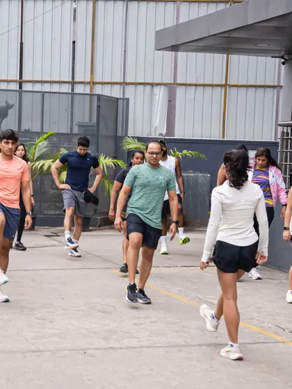It all starts with a proper warm-up. Our coach leads the group through dynamic stretches before we hit the pavement for our Cubbon Park run.