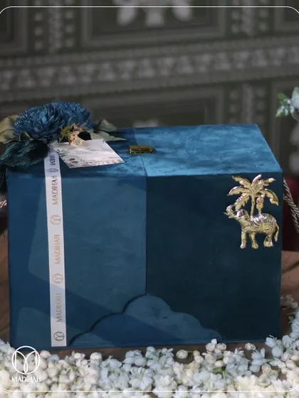 The exterior of the 'Pyaar ka Sandook' mukhwaas box. The deep teal velvet is adorned with a brass elephant motif, a symbol of royalty and good fortune, making the box itself a keepsake.