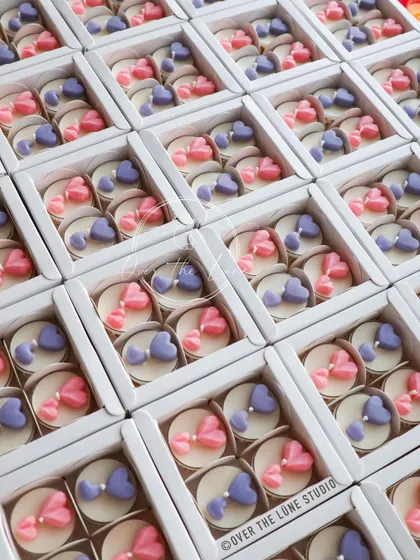 The final packaged sets of heart-themed tealights, ready to be gifted. Each box contains four assorted candles, making them a lovely and affordable party favor.
