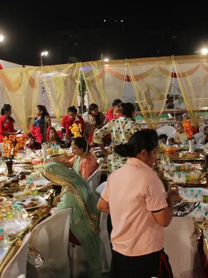 A bustling dining area where guests are enjoying the food and the company, showcasing a successful and well-managed event.