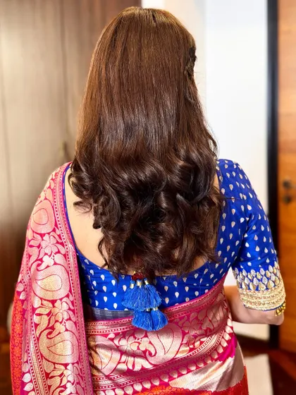 A simple and elegant hairstyle with soft curls at the ends. This is a classic look that never goes out of style.