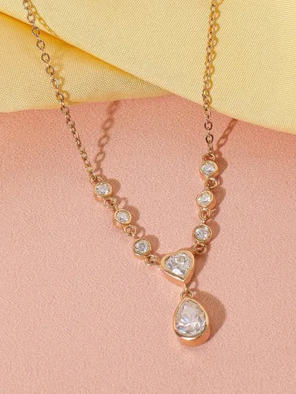 A delicate and modern diamond necklace captured on a soft yellow fabric. The simple styling and warm tones give this piece a contemporary and elegant feel.