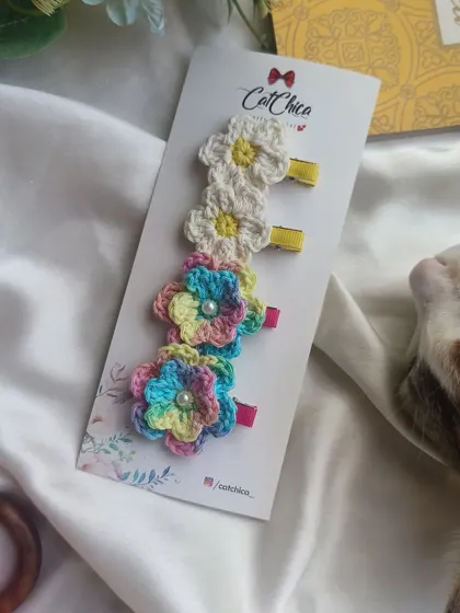 A set of our floral crochet clips, featuring multi-color and daisy designs. These are perfect for adding a touch of nature to your look.