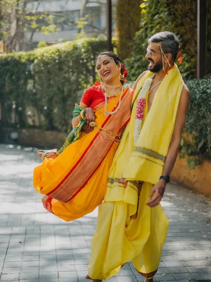 The groom playfully carrying his bride. This shot is full of laughter and joy, perfectly capturing the fun and lighthearted spirit of their relationship on their wedding day.