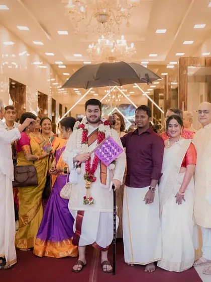 The groom's arrival, surrounded by family, ready to begin the wedding ceremony in a traditional South Indian style.