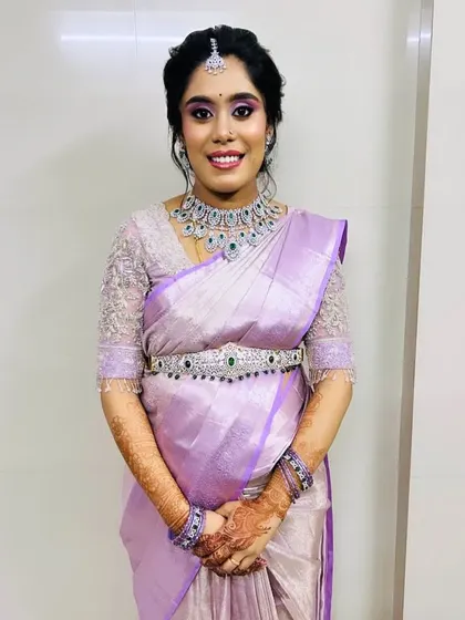 A full view of the client in her lavender saree and AD jewellery. The complete set gives her a polished and put-together look for her special function.