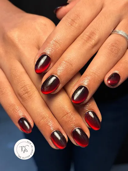 A vampy red and black ombré cat-eye manicure, perfect for a dramatic Diwali look or a sophisticated Halloween vibe.
