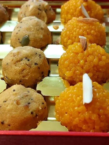 A closer look at the laddoos in our assorted gift boxes. You can see the detail and care that goes into making each piece, from the almond garnish to the texture of the laddoo.