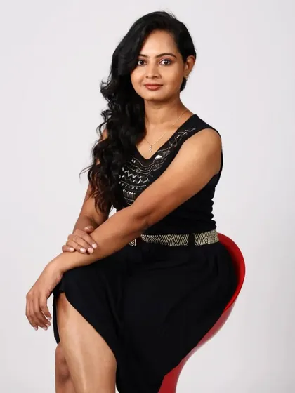 An elegant seated portrait. I gave her a soft glam look with gentle waves in her hair, creating a sophisticated style for her professional photoshoot.