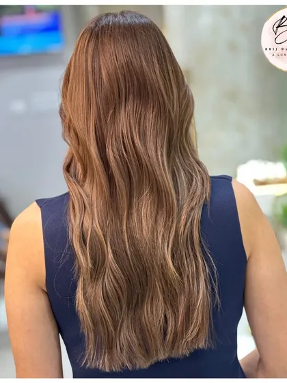 The back view shows the full effect of the balayage, with light-catching tones creating beautiful dimension.