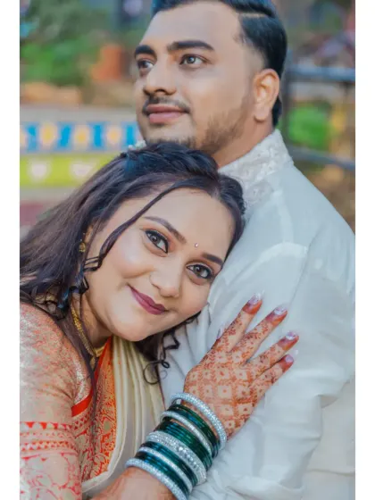 A beautiful close-up portrait of the bride-to-be resting her head on her partner, showcasing her intricate henna and joyful expression.