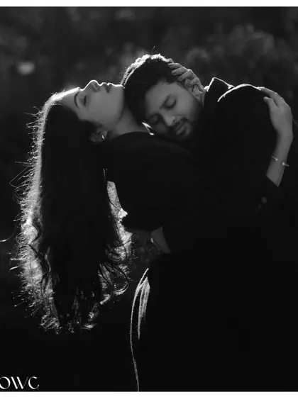 A powerful and intimate black and white portrait of a couple in a deep embrace, showcasing their strong connection.