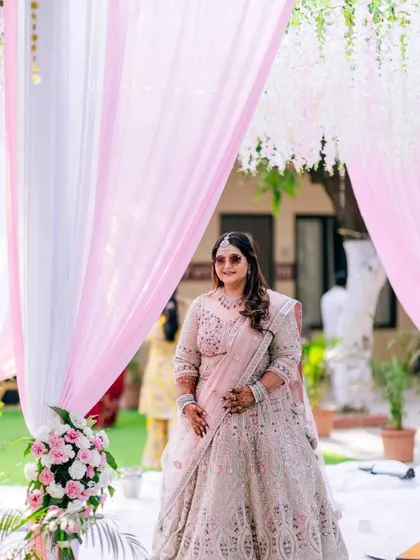A full-length shot of the bride at her outdoor event, looking cool and chic.