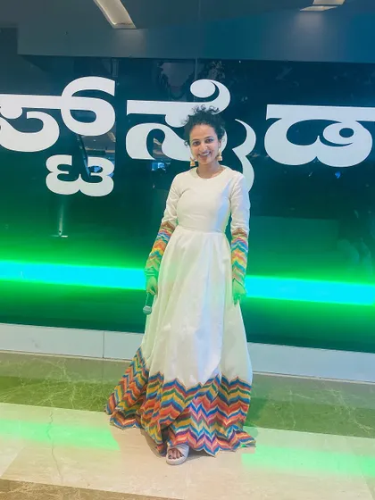 A full-length pose showing the elegant fall of the anarkali gown.