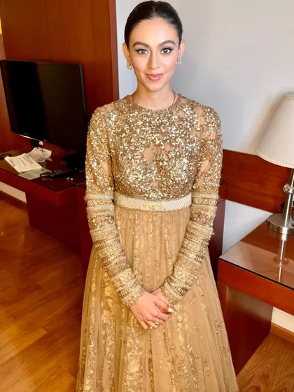 Simplicity meets elegance in this stunning gold Sabyasachi gown. The makeup is clean and minimal, with a sleek bun to complete the look.