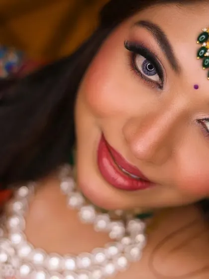 A stunning close-up of the bride, focusing on her expressive eyes and beautiful makeup.