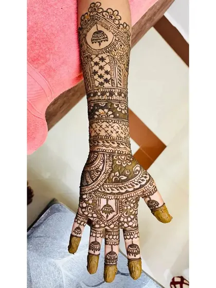 This set shows a popular style with a central personalized element, surrounded by floral and geometric patterns that extend up the arm.