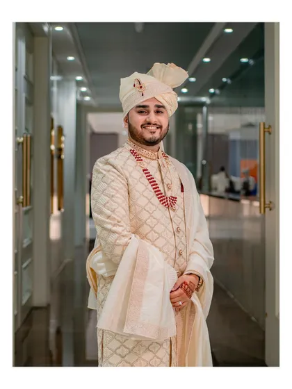 A classic and elegant portrait of the groom in his wedding attire, looking happy and ready for the big moment.