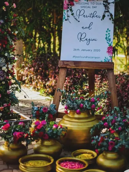 Your welcome area can be beautifully decorated with fresh flowers and traditional brass vessels. This setup not only looks stunning but also serves as a perfect selfie spot for guests.