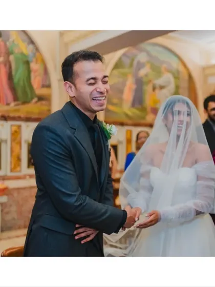 The groom's happy laughter as he exchanges rings with his bride, a moment of pure, unscripted happiness.