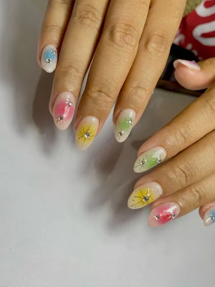 A soft, pastel rainbow set with a "sugar" glitter base and hand-painted starbursts, each accented with a tiny rhinestone.