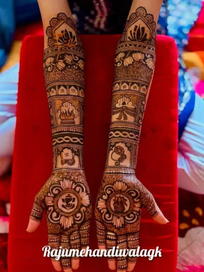 A traditional design with Ganesha mandalas on both palms. The arms are filled with auspicious wedding symbols like the kalash (pot) and shehnai.