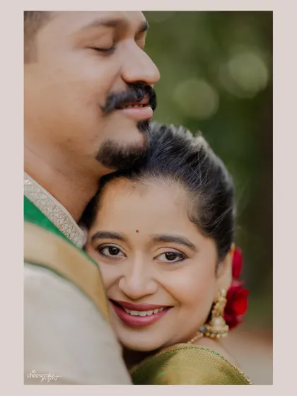 A close-up of the bride peeking out from a hug, her smile is everything.
