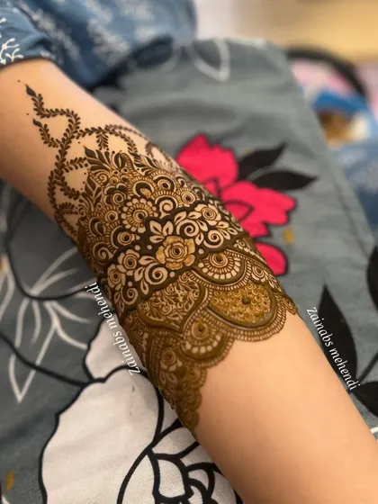 Another angle of Afrah's forearm, highlighting the delicate and flowing design.