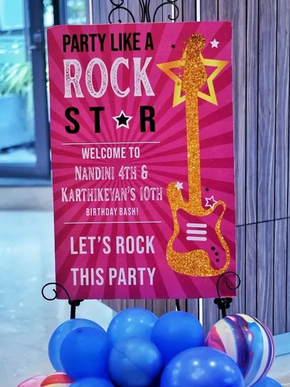 "Party Like a Rockstar!" This welcome sign sets the tone for a high-energy birthday bash. The glittery guitar and bold font immediately get guests excited.