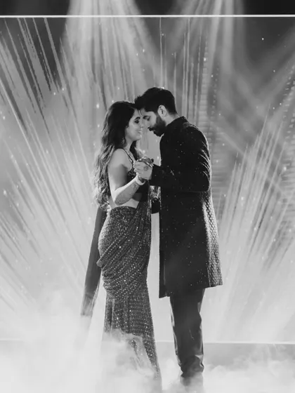A beautiful black and white shot of the couple's first dance, surrounded by ethereal smoke. The dramatic lighting creates a timeless and romantic silhouette.
